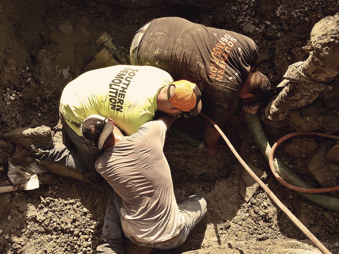 men digging in dirt